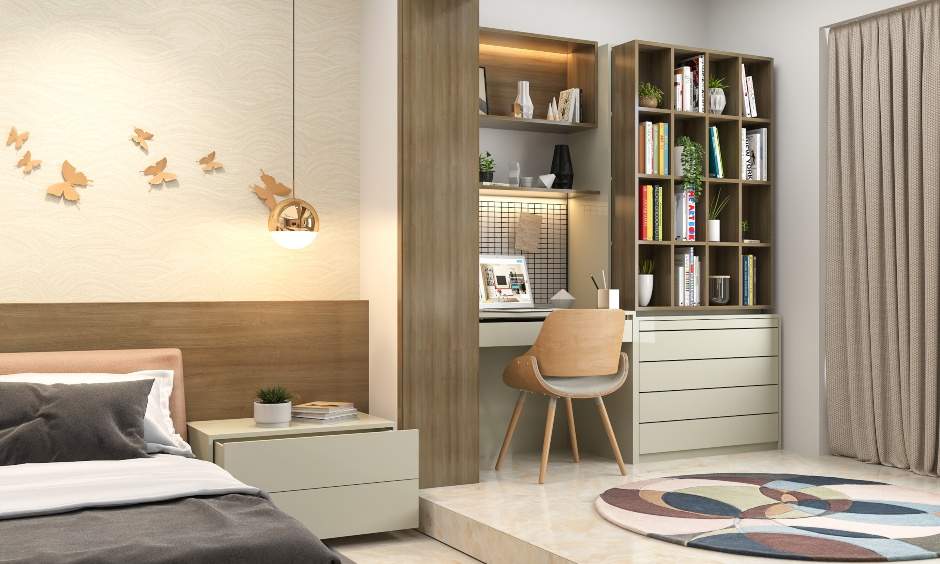 2bhk home interior design with study room adjoining the master bedroom in an open plan is designed with an ergonomic study desk