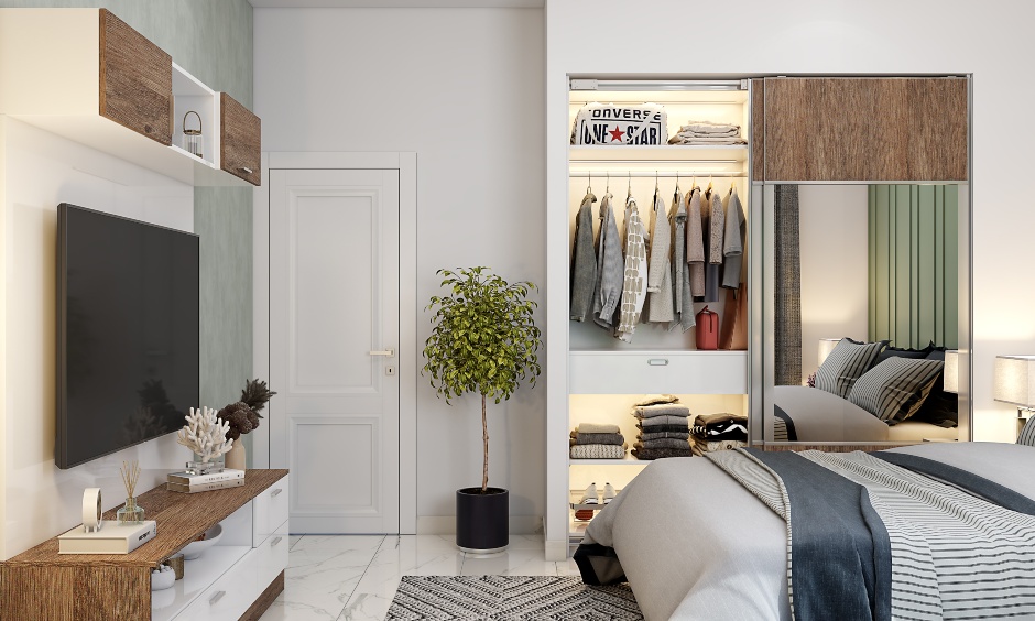 A built-in wardrobe with sliding doors designed with mirrors in a bedroom interior design