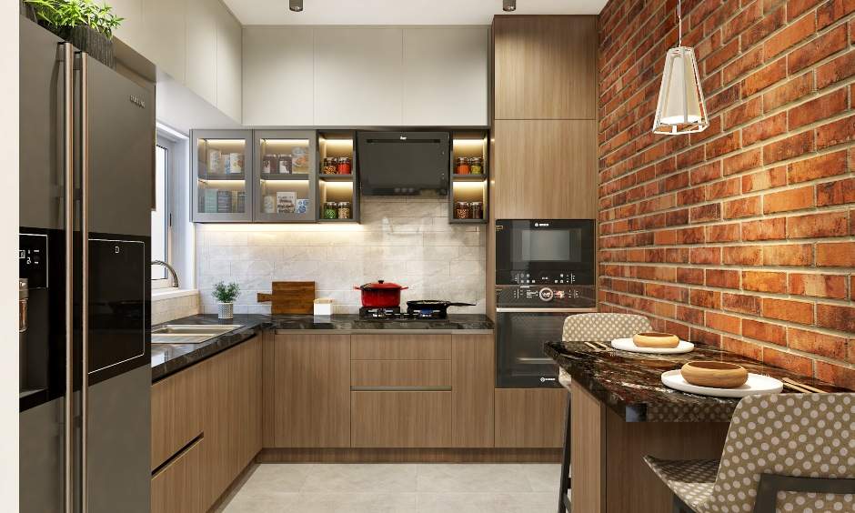 A modular kitchen designed with wood finished laminated cabinets, an appliance garage in a 1bhk flat design