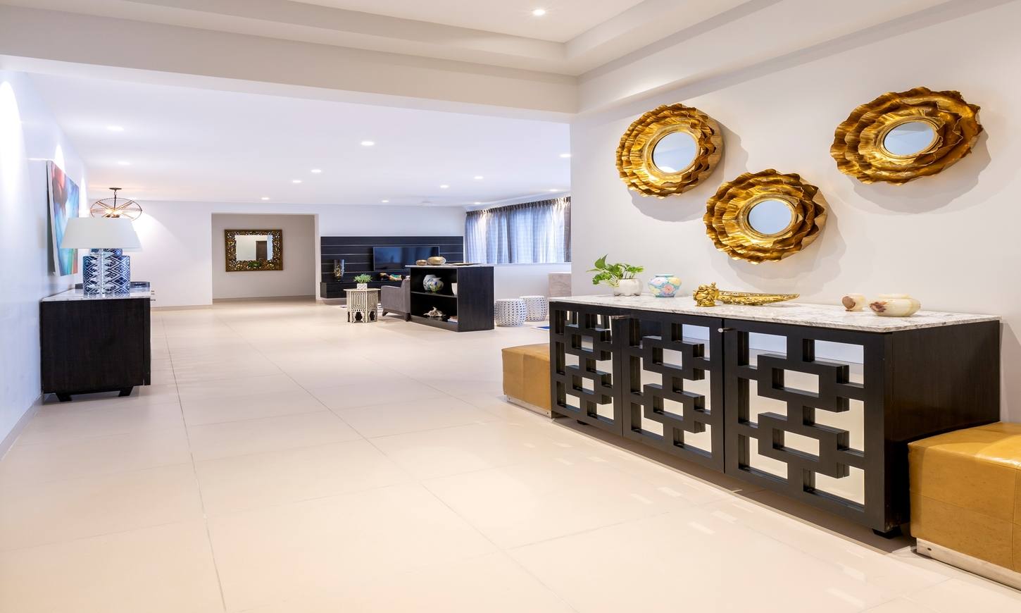 Living room foyer with gold mirror decor by best interior decorators in bangalore