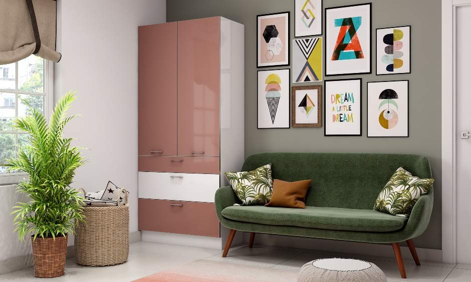 A combination of pink and white kids wardrobe in the bedroom corner