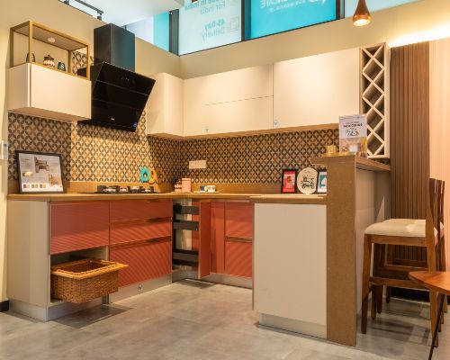 Dual-toned modular kitchen with wicker basket and breakfast countertop at baner