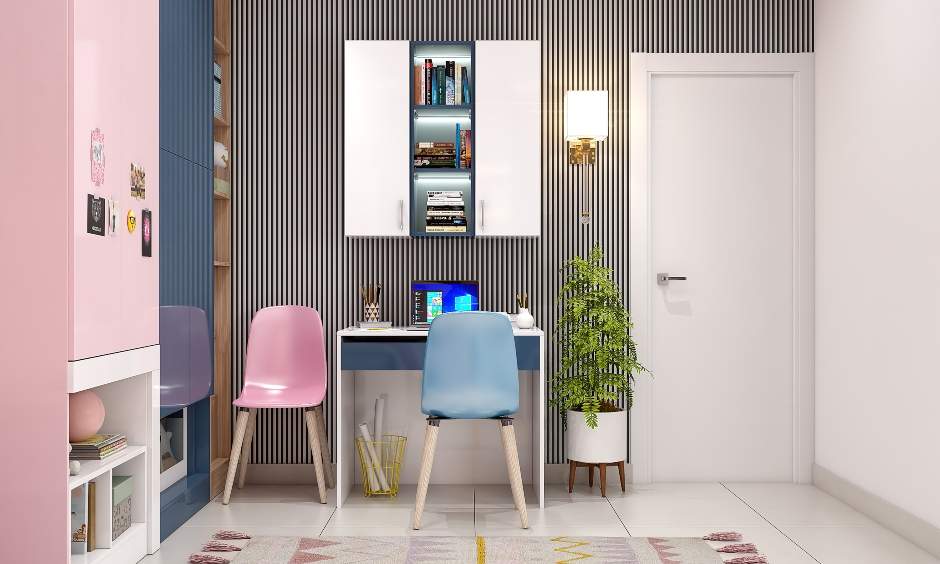 Independent kids study desk with a blue chair and wall-mounted cabinets