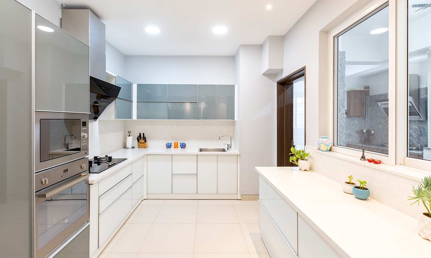 Grey and White u shaped kitchen designed by one of the best interior firms in bangalore