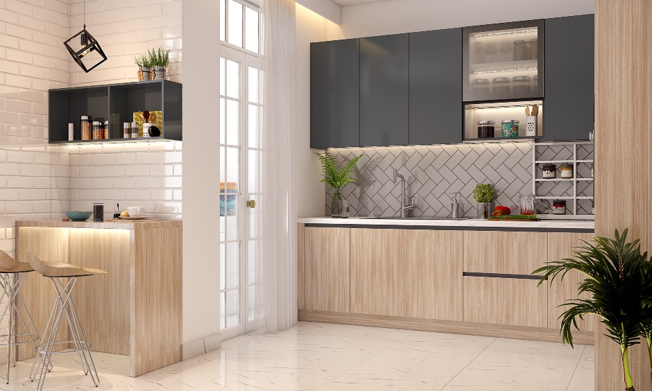 L-shaped modular open kitchen features extended breakfast counter area with tall two chairs