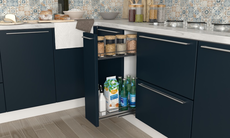 Navy blue and white kitchen design with a oil and spice pull out for storage in kitchen interiors