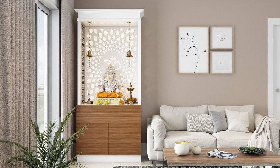 A white pooja unit design hat has a base cabinet made of wooden laminate