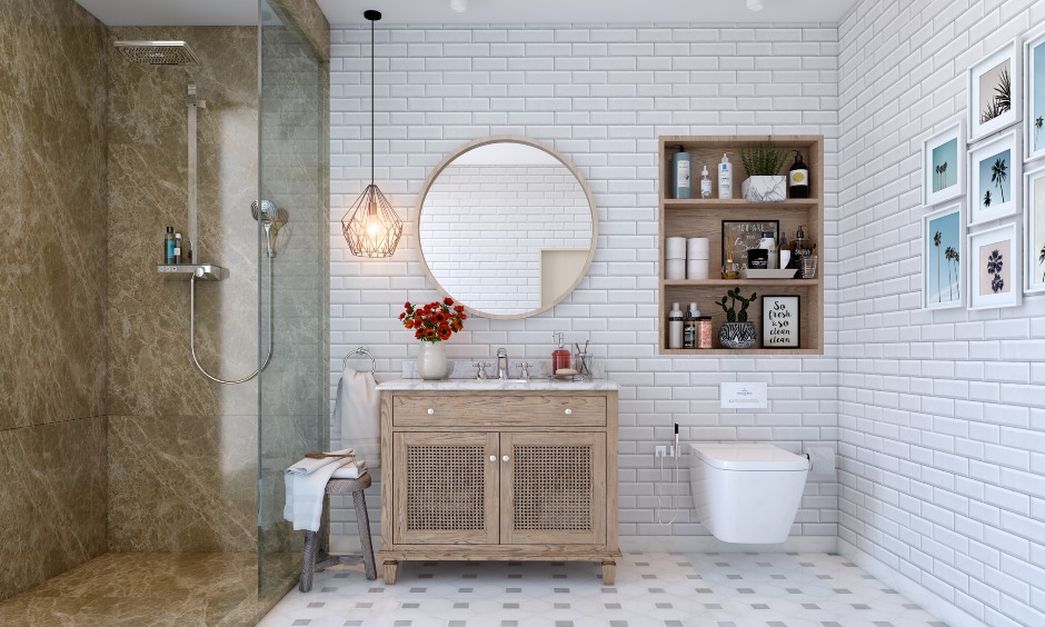 White bathroom interior with a brown marble shower cubicle, wood vanity, and round mirror.